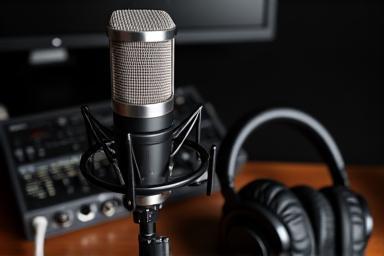 Professional podcasting setup with microphone, headphones, and audio interface